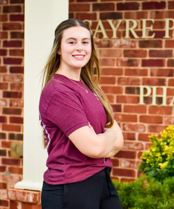 Kinlee Jordan outside Sayre Professional Pharmacy.