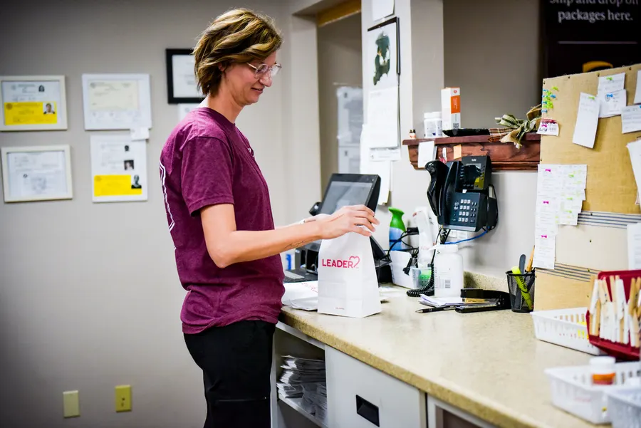 A pharmacy team member preparing prescriptions at the work counter.